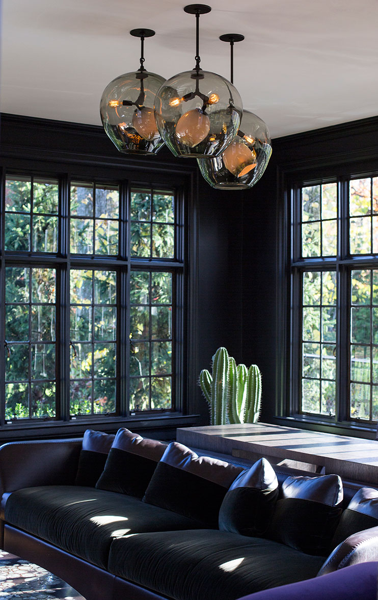 Dark walls with black window frames allow the natural light and view to green foliage beyond to shine, not to mention the beautiful Lindsey Adelman #pendant. #dark #interiors